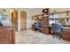 This office features custom dark wood desk and cabinets and a beautiful view of the desert landscape at 26425 Park St, Nelson, NV 89005