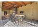 This outdoor kitchen features a bar, grill, ceiling fans and a beautiful desert view at 26425 Park St, Nelson, NV 89005