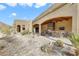 This outdoor kitchen features a bar, grill, and beautiful desert landscaping at 26425 Park St, Nelson, NV 89005