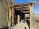 Outdoor patio area with stone flooring and wooden pergola with vines at 26425 Park St, Nelson, NV 89005