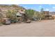 Scenic street view of the property showcasing its rustic charm and vintage vehicles at 26425 Park St, Nelson, NV 89005