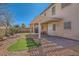 Backyard showcasing a covered patio, artificial turf, and rock landscaping at 2724 Rosarito St, Las Vegas, NV 89108