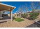 Backyard featuring a covered patio, rock landscaping, and mature trees at 2724 Rosarito St, Las Vegas, NV 89108