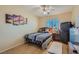 Cozy bedroom featuring a ceiling fan, window, and Las Vegas themed artwork at 2724 Rosarito St, Las Vegas, NV 89108