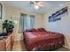 Comfortable bedroom with a floral comforter, wood dresser, and decorative mirror at 2724 Rosarito St, Las Vegas, NV 89108