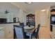 Cozy dining area with a dark wood table, decorative china cabinet, and easy access to the kitchen at 2724 Rosarito St, Las Vegas, NV 89108