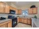 Well-appointed kitchen with wood cabinets, granite countertops, and stainless steel appliances at 2724 Rosarito St, Las Vegas, NV 89108