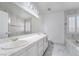 Bathroom has a tub, double vanity, marble floors, and a shower at 4411 Elk Point Cir, Las Vegas, NV 89147