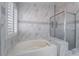 Bathroom features a soaking tub and shower with white marble tile surround at 4411 Elk Point Cir, Las Vegas, NV 89147