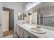 Bathroom has a double vanity, gray walls, white cabinets, and a soaking tub at 4411 Elk Point Cir, Las Vegas, NV 89147