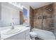 Bathroom featuring tiled walls, a tub, and a single sink vanity at 4411 Elk Point Cir, Las Vegas, NV 89147