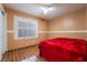Bedroom with wood floors, a ceiling fan, and a bright window with blinds at 4411 Elk Point Cir, Las Vegas, NV 89147