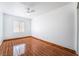 An empty bedroom features wood-look tile flooring and a modern ceiling fan at 4411 Elk Point Cir, Las Vegas, NV 89147