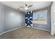 Bedroom with ceiling fan, geometric accent wall and shuttered window at 4411 Elk Point Cir, Las Vegas, NV 89147