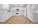 Bright kitchen featuring white cabinets, a stainless steel microwave, and tile flooring at 4411 Elk Point Cir, Las Vegas, NV 89147