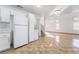 Open floor plan showing kitchen with white appliances that flows into the spacious living area with staircase at 4411 Elk Point Cir, Las Vegas, NV 89147