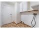 Laundry room featuring tile flooring, white cabinets, and a utility sink at 4411 Elk Point Cir, Las Vegas, NV 89147