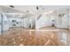 Bright living room and open floor plan with stairs, tile flooring, and a white cabinet kitchen at 4411 Elk Point Cir, Las Vegas, NV 89147