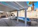 Covered patio with backyard pool, table, and privacy block wall at 4411 Elk Point Cir, Las Vegas, NV 89147