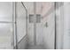 The tiled shower has glass doors and built-in toiletry shelves at 4411 Elk Point Cir, Las Vegas, NV 89147
