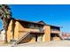 Two-story building featuring staircases, balconies, and a desert landscape at 4791 E Craig Rd, Las Vegas, NV 89115