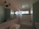Bathroom with shower-tub combo, a large mirror, updated vanity, and decorative tile accents at 5194 Saratoga Dr, Las Vegas, NV 89120