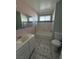 This bathroom features a shower-tub combo, toilet, sink, mirror and a tiled floor at 5194 Saratoga Dr, Las Vegas, NV 89120