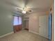 Well-lit bedroom with tile flooring, ceiling fan, pink curtains, and a closet for ample storage at 5194 Saratoga Dr, Las Vegas, NV 89120