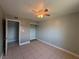 Bedroom featuring tile floors, ceiling fan, and a spacious closet, offering ample space and comfort at 5194 Saratoga Dr, Las Vegas, NV 89120