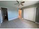This bedroom features tile floors, ceiling fan and light, with an en suite bathroom and large closet at 5194 Saratoga Dr, Las Vegas, NV 89120