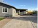 View of the long driveway leading to the covered carport, with backyard fencing visible at 5194 Saratoga Dr, Las Vegas, NV 89120