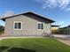 Gray home exterior with artificial lawn and covered carport area next to backyard fencing at 5194 Saratoga Dr, Las Vegas, NV 89120