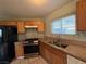 Spacious kitchen with wood cabinetry, granite countertops, stainless steel oven, and large basin sink at 5194 Saratoga Dr, Las Vegas, NV 89120