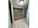 This laundry room has tile floors, built-in shelves and a washer and dryer hook-up at 5194 Saratoga Dr, Las Vegas, NV 89120