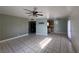Living room with tile flooring, ceiling fan, and view into the kitchen at 5194 Saratoga Dr, Las Vegas, NV 89120