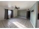 Living room with tile flooring, large window with curtains, and entry door at 5194 Saratoga Dr, Las Vegas, NV 89120