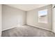 Neutral bedroom featuring soft carpet, light walls and a bright window at 5399 El Nevero St, Las Vegas, NV 89166