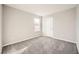 Cozy bedroom featuring plush carpeting, neutral walls, and a bright window at 5399 El Nevero St, Las Vegas, NV 89166