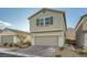 Inviting two-story home featuring a two-car garage and a paver driveway at 5399 El Nevero St, Las Vegas, NV 89166