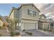 Stylish two-story home with desert landscaping, paver driveway, and attached two-car garage at 5399 El Nevero St, Las Vegas, NV 89166