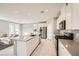Modern kitchen featuring white cabinets, stainless steel appliances, and a spacious island at 5399 El Nevero St, Las Vegas, NV 89166