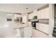 Modern kitchen featuring an island with stainless steel appliances, white cabinets, and light countertops at 5399 El Nevero St, Las Vegas, NV 89166