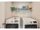 Convenient laundry room equipped with modern, matching front load washer and dryer at 5399 El Nevero St, Las Vegas, NV 89166