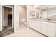 Main bathroom featuring double sinks and white cabinets, offering plenty of counter space at 5399 El Nevero St, Las Vegas, NV 89166