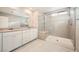 Elegant main bathroom featuring dual sinks, white cabinetry, and a glass-enclosed shower at 5399 El Nevero St, Las Vegas, NV 89166