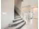 Carpeted staircase with white railing and plenty of natural light at 5399 El Nevero St, Las Vegas, NV 89166