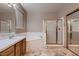 Well-lit bathroom featuring neutral tones, a soaking tub, a separate shower, and ample counter space at 5416 Irish Spring St, Las Vegas, NV 89149