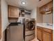 Well-organized laundry room with modern washer and dryer, storage cabinets, sink, and bright lighting at 5416 Irish Spring St, Las Vegas, NV 89149