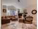 A well-lit living room features tile floors, a fireplace, and large windows draped with elegant white curtains at 5416 Irish Spring St, Las Vegas, NV 89149