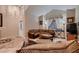 Bright living room featuring tile flooring, cozy furnishings, and large windows allowing for ample natural light at 5416 Irish Spring St, Las Vegas, NV 89149